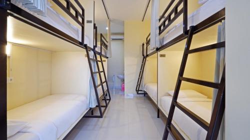 a hallway with bunk beds in a dorm room at V Canggu Dormitory in Canggu