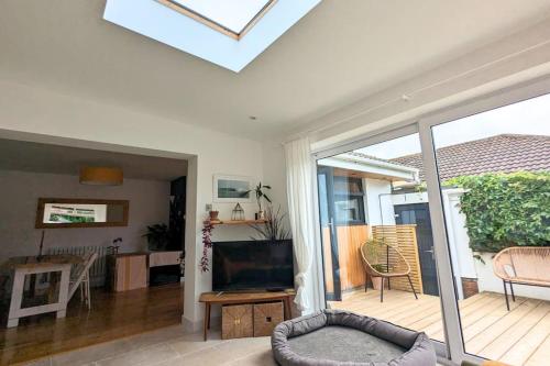 a living room with a television and a balcony at 1 Mint Park Road in Braunton