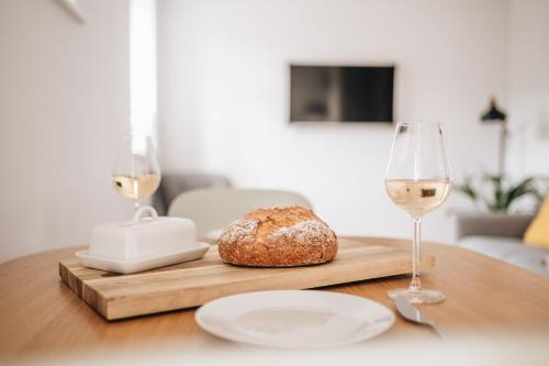 a table with a bread and two glasses of wine at The Old Granary in Barnetby le Wold