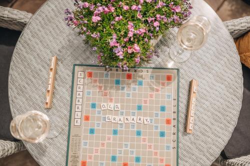 a table with a calendar and a vase of flowers at The Old Granary in Barnetby le Wold