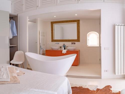a white bathroom with a tub and a sink at Casa Salvi Positano in Positano