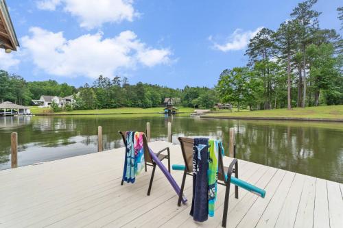 two chairs on a dock next to a lake at Lake Sinclair in Eatonton