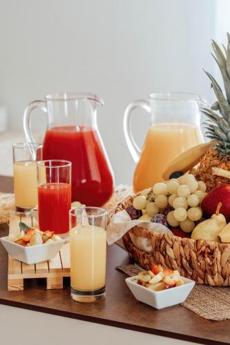 a tray of food with fruit and juice on a table at Hotel Belvedere San Gottardo by LVG Hotel Collection in Verbania