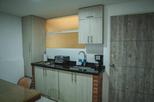 a kitchen with a sink and a counter top at COLIBRI Gorgeous new flat with balcony and terrace in Cali