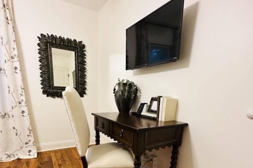 a room with a desk with a television and a chair at Discover Decatur in Decatur
