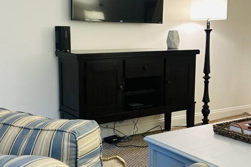 a living room with a black cabinet with a television on it at Discover Decatur in Decatur