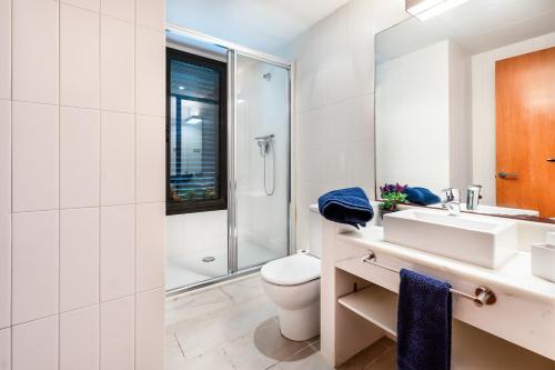 a bathroom with a toilet and a sink and a shower at Villa Marimar - Private Pool in Bonmont Terres Noves