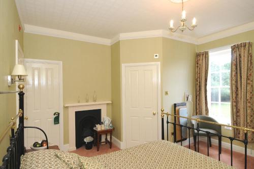 a bedroom with a bed and a fireplace at Old Rectory in Wem