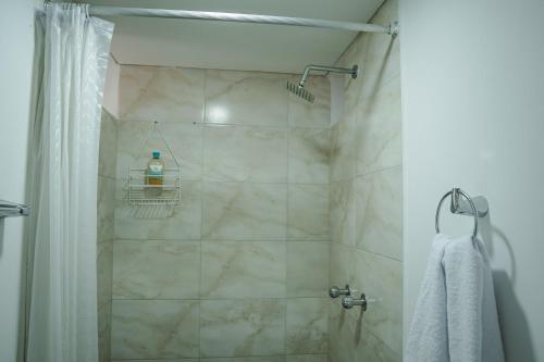 a bathroom with a shower with a bottle of soap at COLIBRI Gorgeous new flat with balcony and terrace in Cali