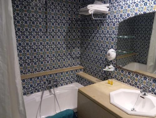 a bathroom with a tub and a sink at Hammamet Serail in Hammamet