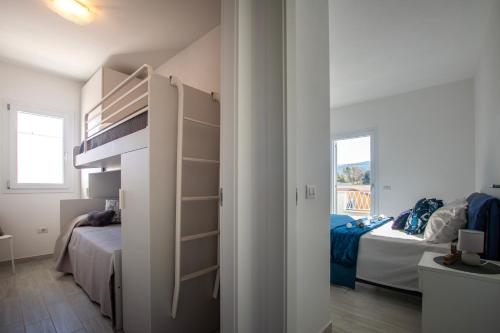 a small bedroom with two beds and a room with a closet at Pietra di Luna in Valledoria