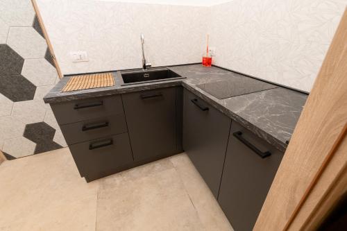 a kitchen with a sink and a counter top at Santa Lucia Affittacamere in Gioia del Colle