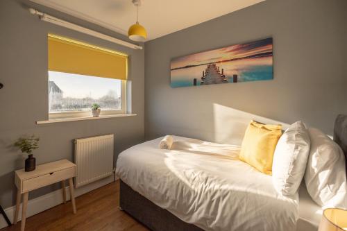 a bedroom with a white bed and a window at Pine House By Horizon Stays in Hartlepool
