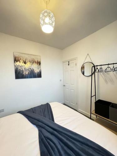 a bedroom with a bed and a painting on the wall at Cosy home in Barnsley centre in Barnsley