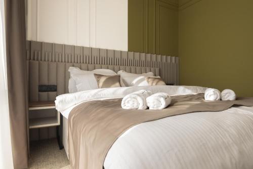 a bedroom with two beds with towels on them at RIVA sleep & chill in Valjevo