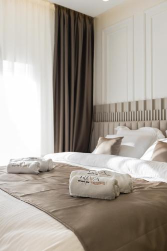 two beds in a bedroom with towels on them at RIVA sleep & chill in Valjevo