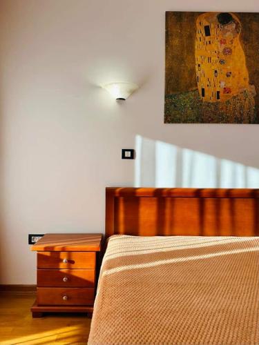 a bedroom with a bed and a dresser and a painting at SeaScape in Bar