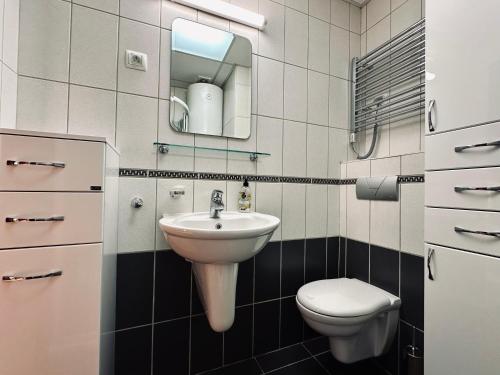 a bathroom with a sink and a toilet at SeaScape in Bar