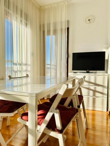 a dining room with a white table and two chairs at SeaScape in Bar