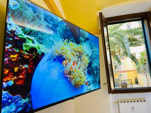 a large flat screen tv hanging on a wall at Colosseum-Apartments in Rome