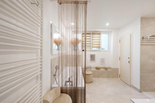 a bathroom with a shower and a toilet and a tub at Villa standing Biarritz in Biarritz
