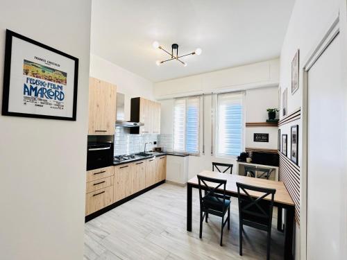 a kitchen with a table and chairs in a room at Vacanze Romane in Lido di Ostia