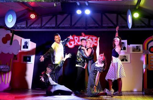 a group of people performing on a stage at Camping Village Baia Azzurra in Castiglione della Pescaia