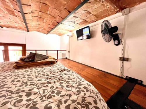 a bedroom with a bed and a fan on the wall at P3 Estudio con cocina!Balcón privado! 2`del metro P3 in Barcelona