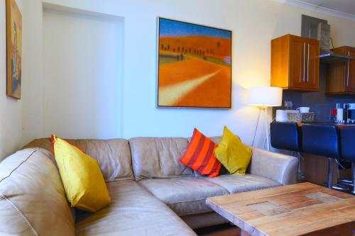 a living room with a couch and a table at 1 minute from Royal Mile, Large 5 Bed Apartment in Edinburgh