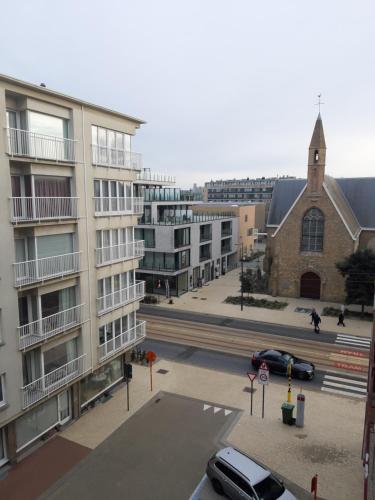 a view of a street with buildings and a church at Oostduinkerke Apartments in Oostduinkerke