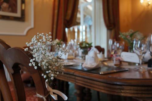 a wooden table with flowers on top of it at Old Rectory in Wem