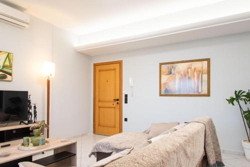 a living room with a couch and a tv at Sky 7 View Apartment in Heraklion