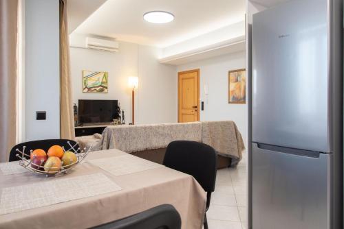 a kitchen with a table with a bowl of fruit on it at Sky 7 View Apartment in Heraklion