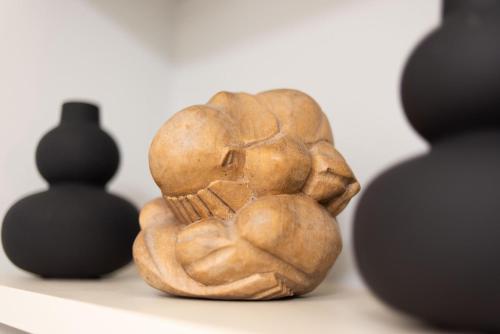 a statue of a skull sitting next to black objects at Sky 7 View Apartment in Heraklion