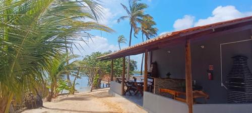 a house on the beach with a view of the water at Chalé Brisa da Lagoa in Icaraí