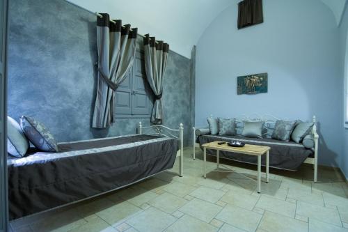 a living room with a tub and a couch at Polydefkis Hotel in Kamari