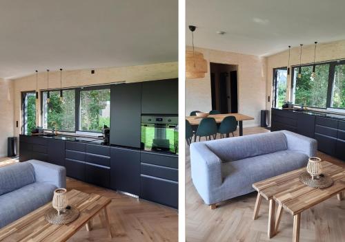 a kitchen and living room with a blue couch and a table at Bramendijk in Groede