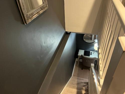 a stairway with a toilet and a mirror on the wall at The Old Farmhouse in Bristol
