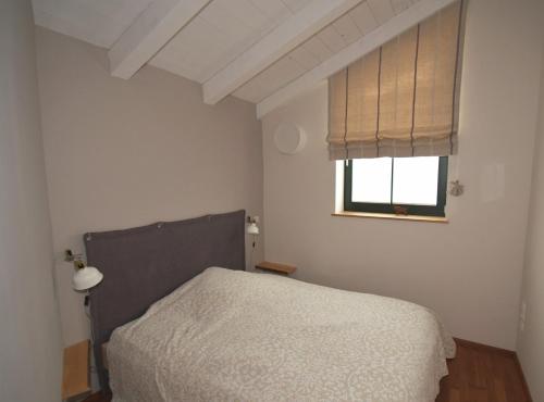 a bedroom with a bed and a window at Ferienwohnung Vogelnest in Prien am Chiemsee