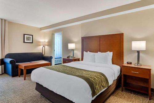 a hotel room with a large bed and a chair at Comfort Inn Douglasville - Atlanta West in Douglasville