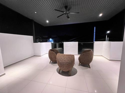 a room with four chairs and a ceiling fan at [New Double Storey] 12 to 14 Pax - SG ABONG - BRIGHT INN HOMESTAY in Muar