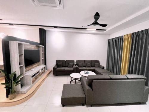a living room with a couch and a tv at [New Double Storey] 12 to 14 Pax - SG ABONG - BRIGHT INN HOMESTAY in Muar