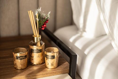 a table with a vase with flowers and bamboo sticks at RIVA sleep & chill in Valjevo