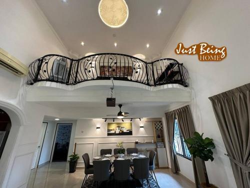 a dining room with a table and chairs and a balcony at Just Being Home 10pax 3BR/3BA 4Queen/1Sofa in Ampang