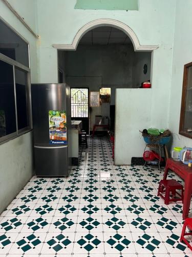 a kitchen with a refrigerator and a tiled floor at Nhà Nghỉ SAM SILK in Quy Nhon