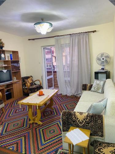 a living room with a couch and a table at Mollys apartment 1 in Pogradec