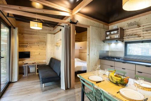 a kitchen and dining room with a table in a room at CityKamp Paris in Paris