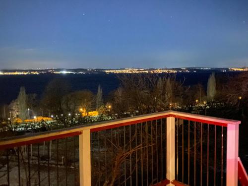a view of a city from a balcony at night at Brunstorpsgård Bränneriet in Huskvarna
