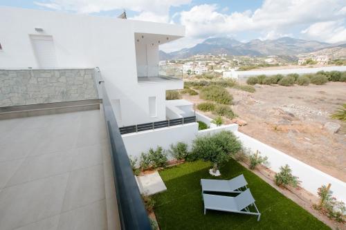 a view from the balcony of a house with a small yard at Villa Marina Hills in Makry Gialos