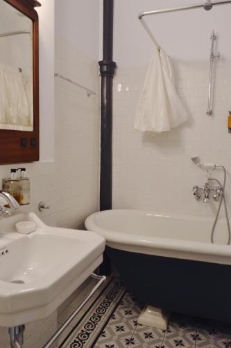 a bathroom with a bath tub and a sink at Chopin Boutique in Warsaw